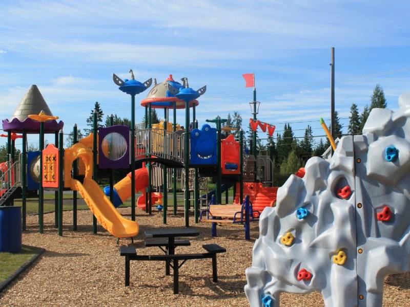 Colorful community playground in Shannon Quebec featuring climbing walls, slides, and weather-resistant play equipment.